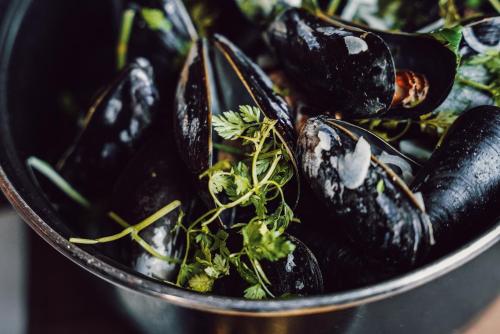 a bowl of food with mussels on a table at Clarion Hotel Energy in Stavanger