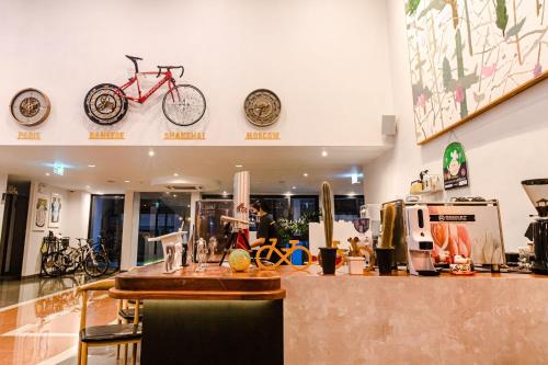 a store with a bike hanging on the wall at Tour De Phuket Hotel - SHA Plus in Thalang