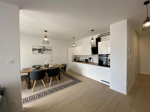 a kitchen and dining room with a table and chairs at New modern APT near Old town - private parking in Zadar