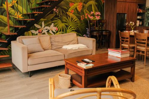 a living room with a couch and a coffee table at FlowerGod PentStudio Tay Ho Hanoi in Hanoi