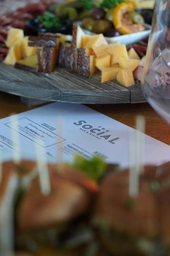a table with two plates of food with cheese and fruit at Clarion Hotel Tyholmen in Arendal