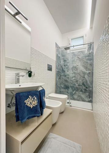 a bathroom with a shower and a toilet and a sink at Taormina 10 PANTA REI Fontane Bianche in Fontane Bianche