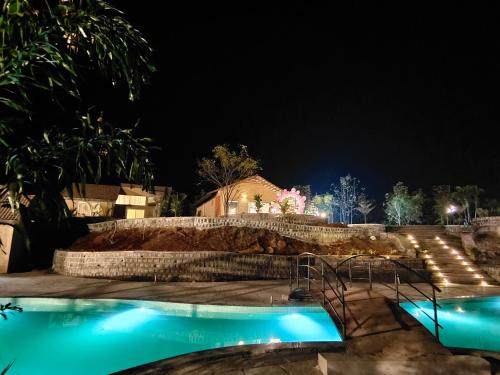 a night view of a swimming pool at night at Waterstone resort in Linga