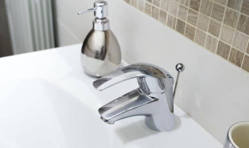 a bathroom sink with a faucet on a counter at PeoniaMaximaHouse -Piazza Bologna- in Rome