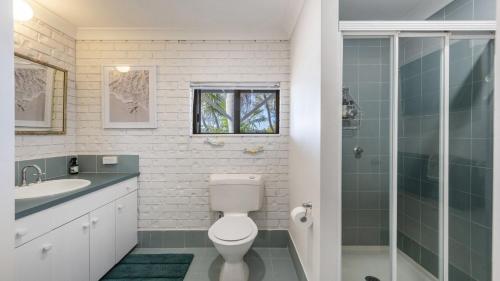 a bathroom with a toilet and a sink and a shower at Copacabana House - Absolute Waterfront, Private Jetty in Yamba