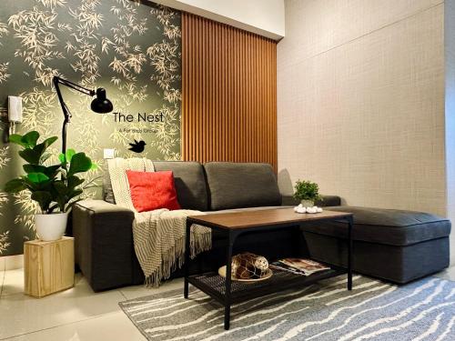 a living room with a couch and a table at Cozy Hyve Soho Suites in Cyberjaya
