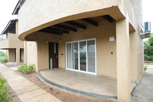 a building with a large glass door on it at Waterstone resort in Linga