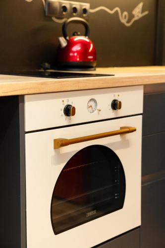 a white oven with a red kettle on top of it at Valaoritou 3 Luxury Rooms in Thessaloniki