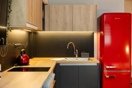a kitchen with a red refrigerator and a sink at Valaoritou 3 Luxury Rooms in Thessaloniki