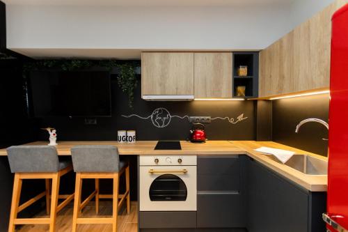 a kitchen with a counter with a stove and a sink at Valaoritou 3 Luxury Rooms in Thessaloniki