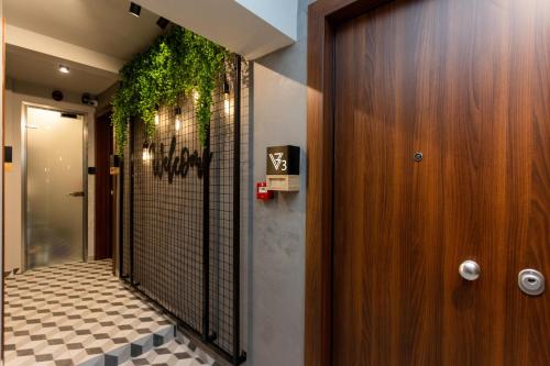a hallway with a door with a plant on the wall at Valaoritou 3 Luxury Rooms in Thessaloniki
