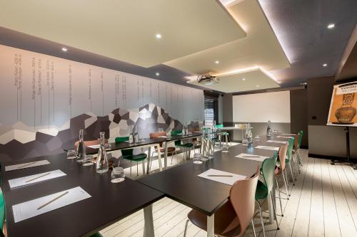 a conference room with a long table and chairs at Alpina Eclectic Hotel in Chamonix-Mont-Blanc