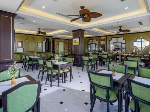 a dining room with tables and chairs in a restaurant at Charming beauty hotel in Da Nang