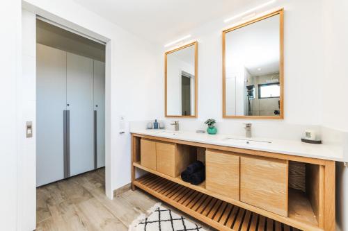 a bathroom with two sinks and a mirror at Modern Penthouse - Nautilya BS1 in Grand Baie