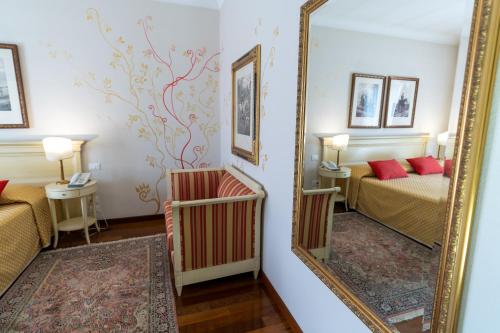 a mirror in a hotel room with a bed and a bedroom at Le Muse Hotel in San Bonifacio