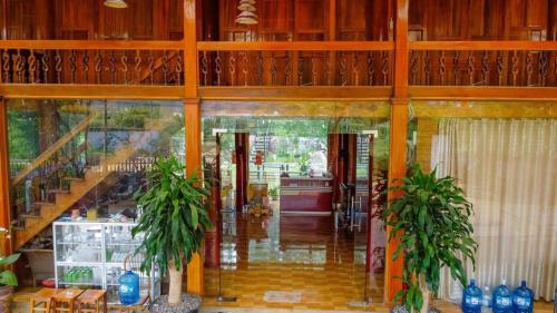 a hallway of a house with two potted plants at Homestay Bản Búa in Mộc Châu