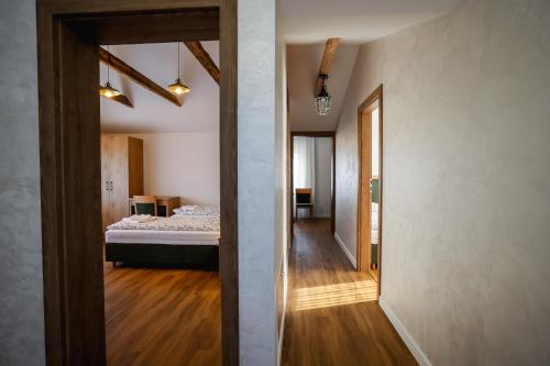 a room with a bed and a hallway at Dom do wynajęcia z tarasem i ogrodem, balia, ognisko in Sandomierz