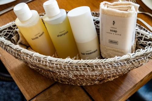a basket with four bottles of sunscreen on a table at Zug Zugersee Lake- and Mountainview House with charm in Zug