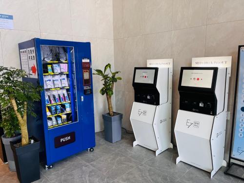 a gas station with two vending machines and a soda machine at SurfingStay in Yangyang