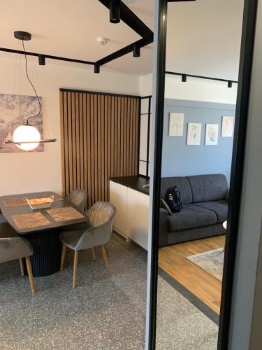 a living room with a table and a couch at Modern Mountain in Kolašin