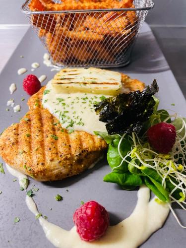 a plate of food with meat and a salad at Piano in Nowy Sącz