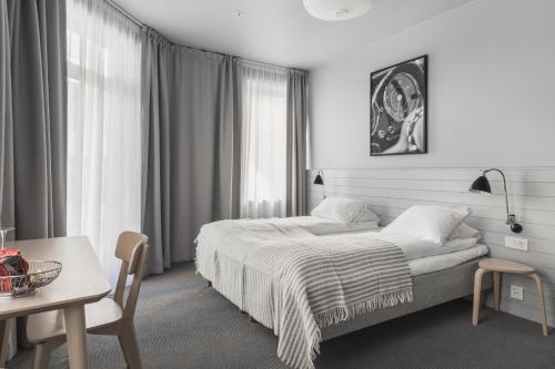 Postel nebo postele na pokoji v ubytování Heimen Hotel