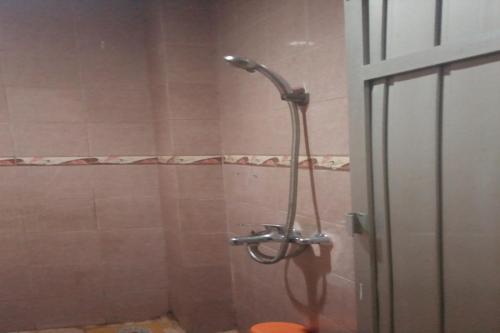 a shower in a bathroom with a glass door at OYO 93060 Wisma Astukara Syariah in Enrekang