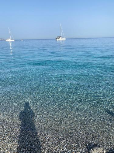 a shadow of a person standing in the water at Brezza Marina in Scilla