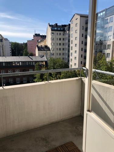 a balcony with a view of a city at Top floor one bedroom apartment with balcony in Helsinki