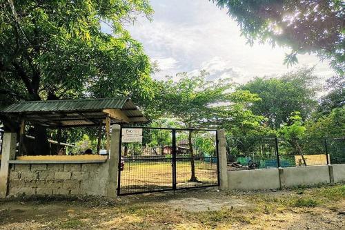 a gate with a fence in front of a zoo at Albert's Transient House in Batangas City