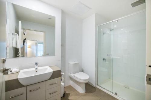 a bathroom with a sink and a toilet and a shower at Quest Wodonga in Wodonga