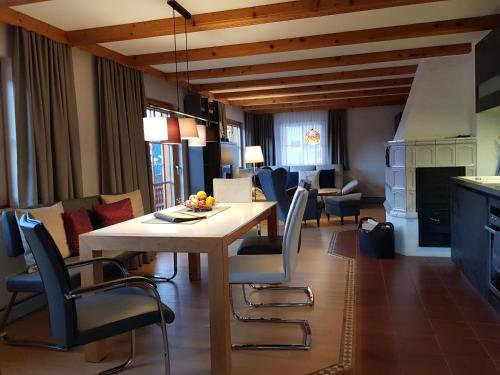 a kitchen and living room with a table and chairs at Panorama Chalet Montafon in Bartholomäberg