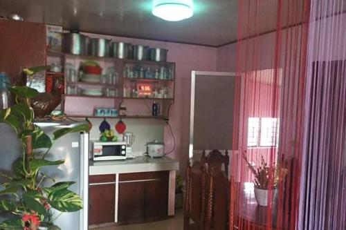a kitchen with a refrigerator and a microwave at Albert's Transient House in Batangas City
