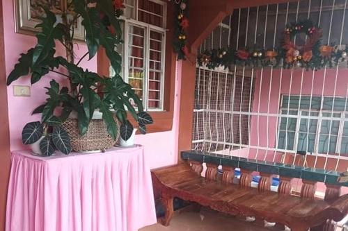 a room with a table and a bench and a window at Albert's Transient House in Batangas City