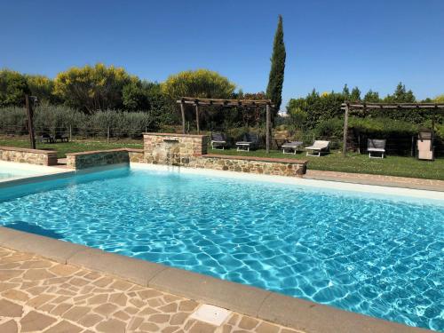 Osteria Delle NociにあるISA - Luxury Resort with swimming pool immersed in Tuscan nature, apartments with private outdoor area with panoramic viewの庭の大型スイミングプール