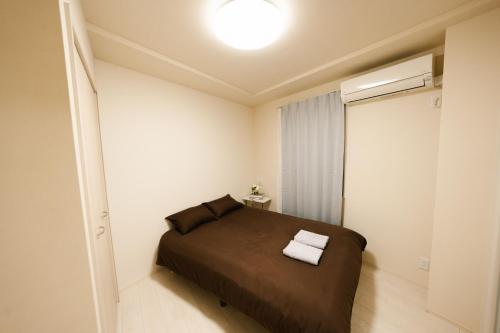 Ένα ή περισσότερα κρεβάτια σε δωμάτιο στο FL Residence Shinjuku II