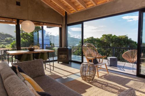 a living room with a couch and a table and chairs at Lava Homes in Santo Amaro