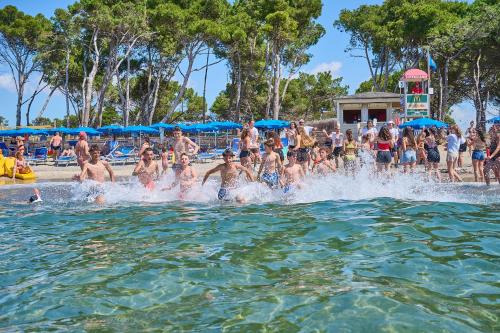 a group of people in the water at a swimming pool at Villaggio Orizzonte in Riotorto