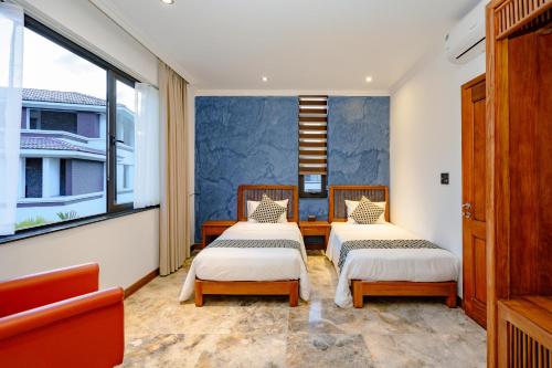 two beds in a room with a window at Villa FLC Hạ Long bt3-6 in Ha Long