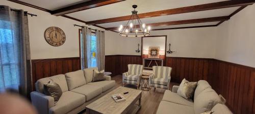 a living room with a couch and a table at Whole House 85 Acre Private Ranch Sleeps 8, hot-tub king beds in Logan