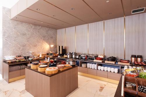 a restaurant kitchen with a counter with food on it at Tosei Hotel Cocone Tsukiji Ginza Premier in Tokyo