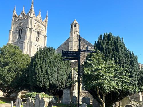 an old church with a clock tower and trees at Park View is a beautiful whole entire house close to town centre, sleeps 8 in 4 rooms, 2 doubles and 4 single beds with 2 shower rooms, available for holidays, insurance stays, trades people, contractors, pets welcome in Wisbech