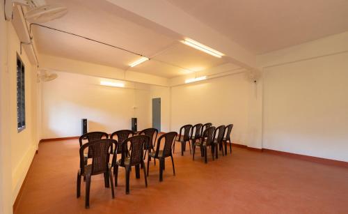 a row of chairs in an empty room at Misty Heights by The Sanihara in Vayittiri