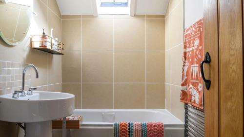 a bathroom with a sink and a bath tub at 5 Bodafon Country Estate in Penrhos-Lligwy