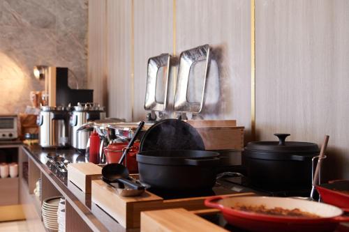 a kitchen with pots and pans on a stove at Tosei Hotel Cocone Tsukiji Ginza Premier in Tokyo