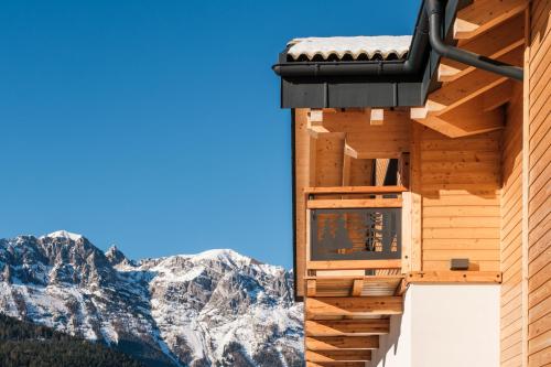 a building with a view of the mountains at La Dila Dolomiti Mountain Lodge in Andalo