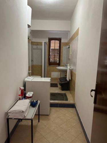 a bathroom with a toilet and a sink at Lido Apartments in Sciacca