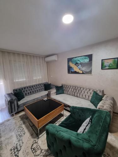 a living room with a couch and a table at Avio Lux Apartmani in Novi Pazar