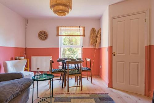 a living room with a table and a dining room at The Courtyard in Folkestone