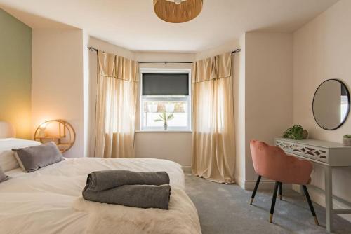 a bedroom with a bed and a desk and a mirror at The Courtyard in Folkestone
